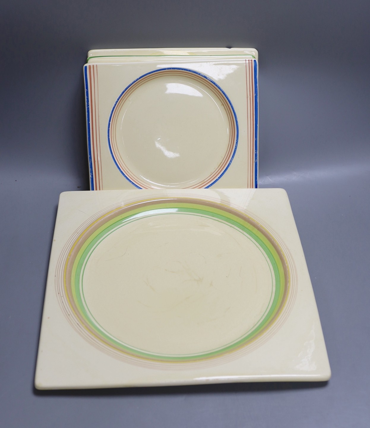 A group of six Clarice Cliff Biarritz plates, various Polly crime geometric designs